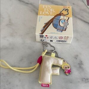 Pop Mart 'F' Keychain with Yellow Strap